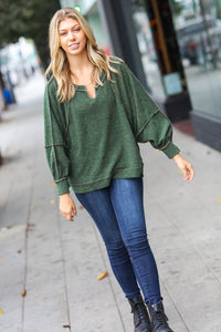 The Slouchy Two Tone Knit Notched Raglan Top in Olive
