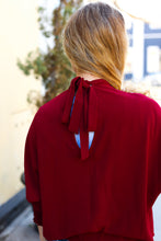 Load image into Gallery viewer, Bold Dreams Smocked Three Quarter Sleeve Tie Back Top in Wine
