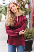 Load image into Gallery viewer, Holiday Vibes Frill Detail Tie Neck Satin Top in Burgundy
