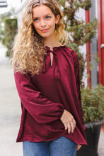 Load image into Gallery viewer, Holiday Vibes Frill Detail Tie Neck Satin Top in Burgundy
